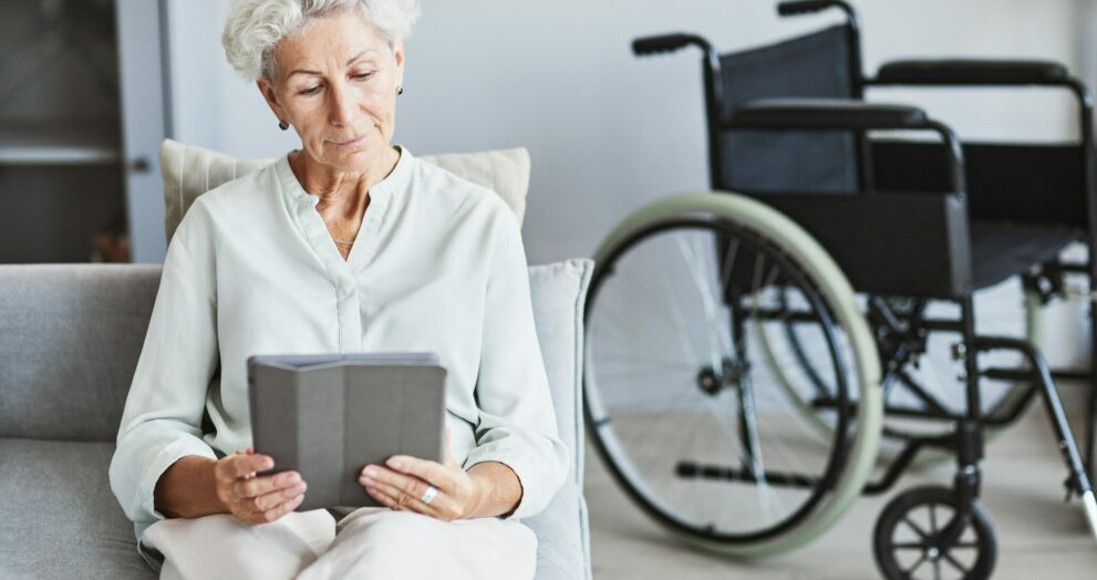 Senior Woman Using Tablet on Couch