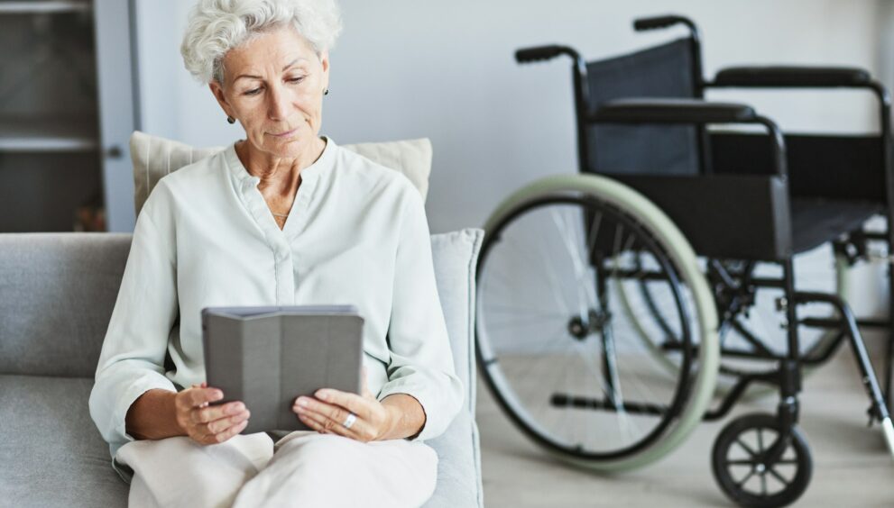 Senior Woman Using Tablet on Couch